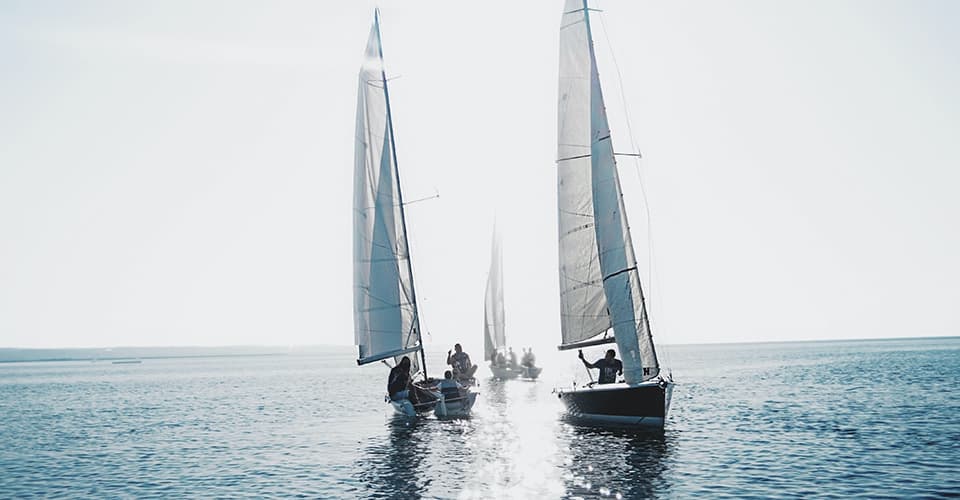 three sailing boats in light winds
