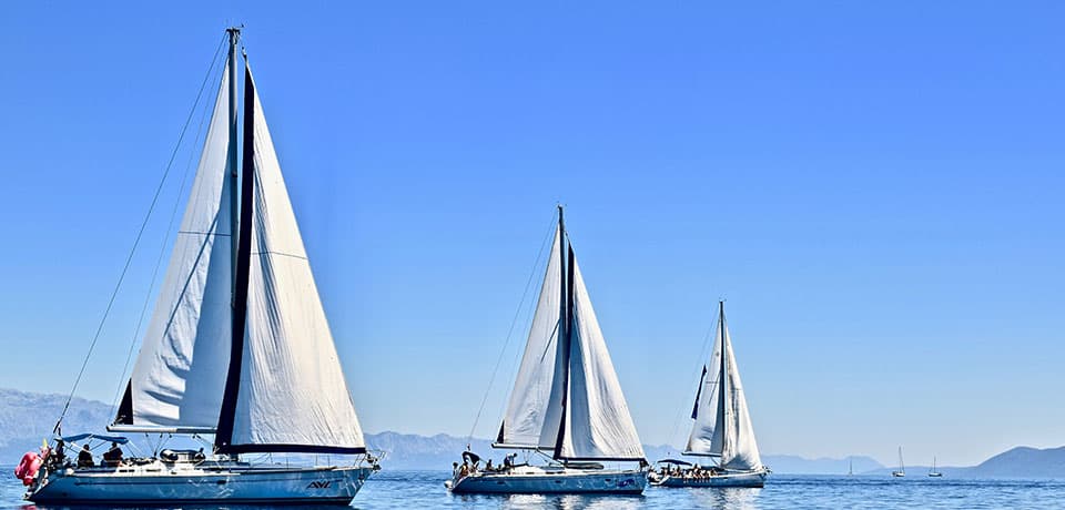 three Beneteau yachts in light winds