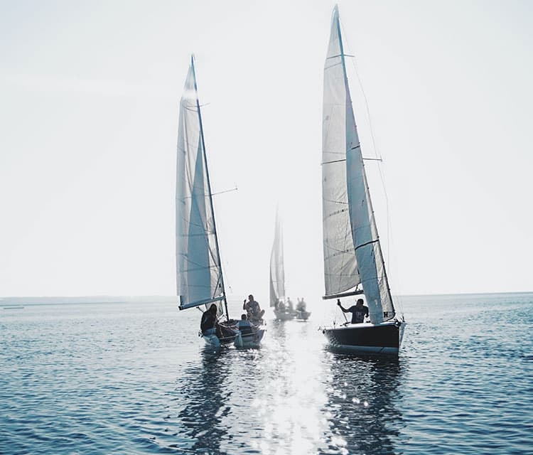 three sailing boats in light winds